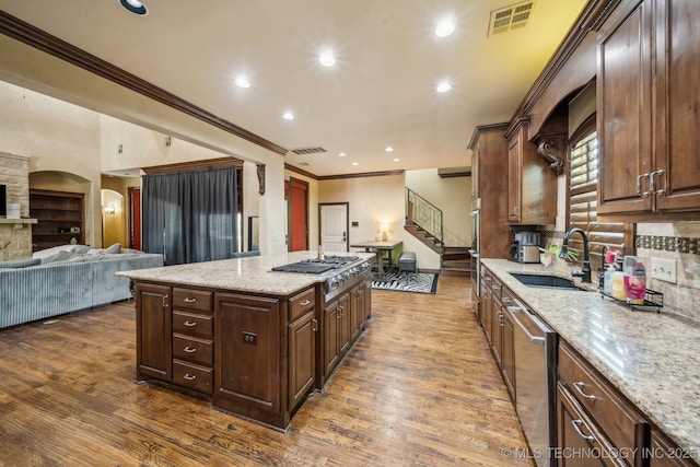 10848 S 95th E Ave, Tulsa, OK 74133 - kitchen featuring stainless steel appliances, a center island, a sink, visible vents, and crown molding