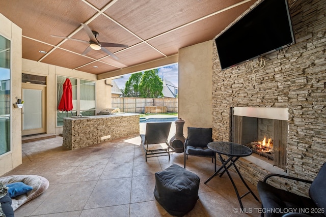 10848 S 95th E Ave, Tulsa, OK 74133 - view of patio with fence, an outdoor stone fireplace, a ceiling fan, and area for grilling