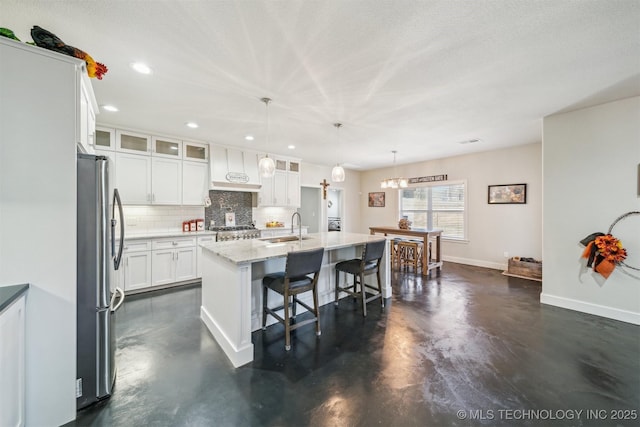 11210 W 178th St, Skiatook, OK 74070 - kitchen with freestanding refrigerator, concrete floors, a sink, tasteful backsplash, and baseboards