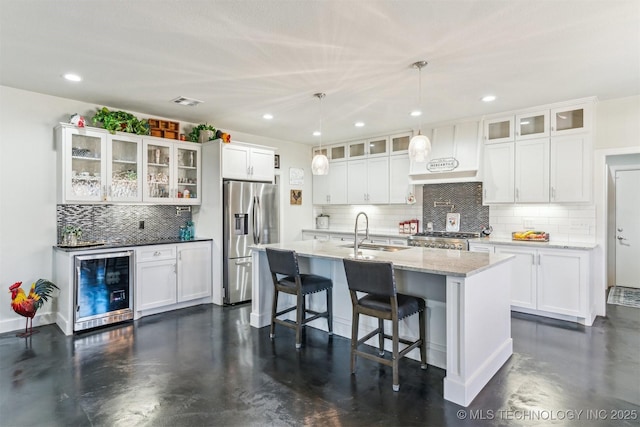 11210 W 178th St, Skiatook, OK 74070 - kitchen featuring stainless steel refrigerator with ice dispenser, premium range hood, wine cooler, stove, and backsplash
