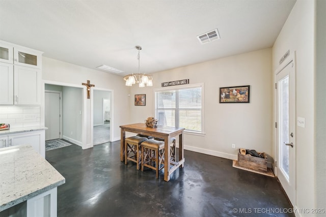 11210 W 178th St, Skiatook, OK 74070 - dining room featuring concrete flooring, a chandelier, and baseboards