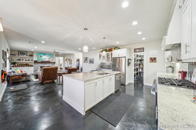 11210 W 178th St, Skiatook, OK 74070 - kitchen featuring stainless steel appliances, finished concrete floors, recessed lighting, tasteful backsplash, and white cabinetry