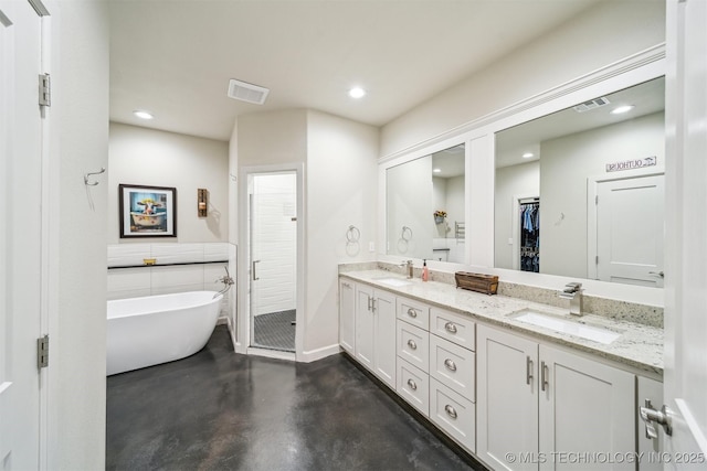 11210 W 178th St, Skiatook, OK 74070 - bathroom featuring finished concrete floors, double vanity, a stall shower, a soaking tub, and recessed lighting