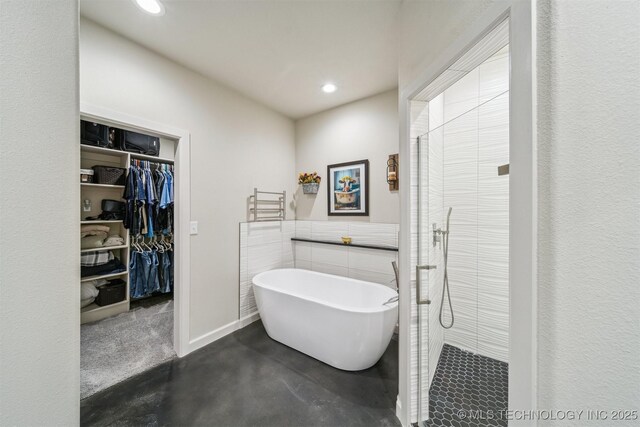 11210 W 178th St, Skiatook, OK 74070 - bathroom with a tile shower, a soaking tub, recessed lighting, a spacious closet, and finished concrete flooring