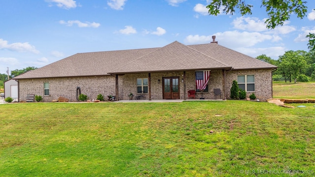 11210 W 178th St, Skiatook, OK 74070 - view of front of property with a front yard, a chimney, brick siding, french doors, and a shingled roof