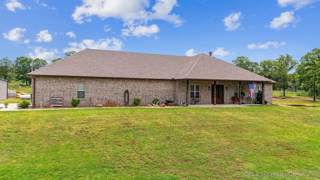11210 W 178th St, Skiatook, OK 74070 - view of front of house with a front yard, roof with shingles, and brick siding