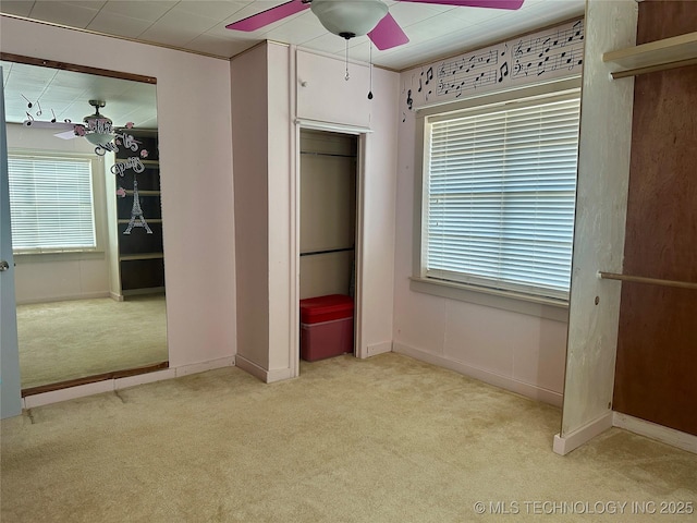 unfurnished bedroom with ceiling fan, baseboards, and carpet