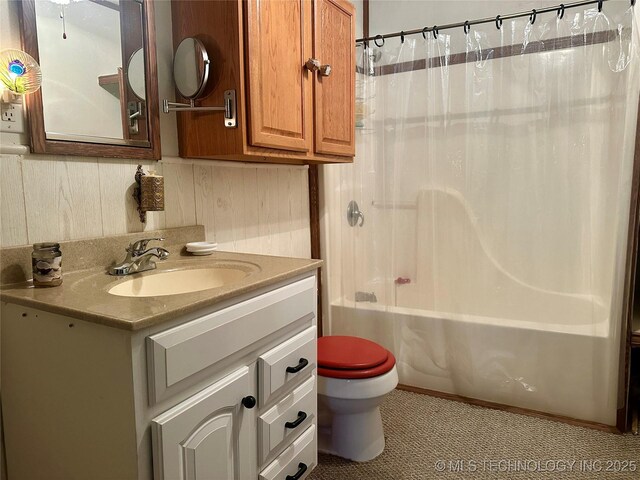 bathroom featuring vanity, toilet, and shower / tub combo with curtain