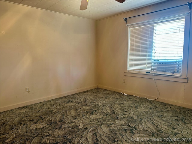 carpeted empty room with baseboards and a ceiling fan