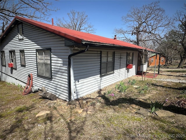 view of home's exterior featuring metal roof