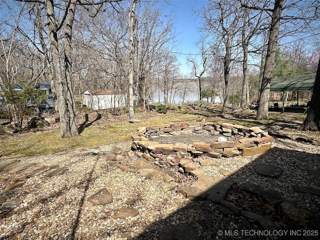 view of yard with a fire pit