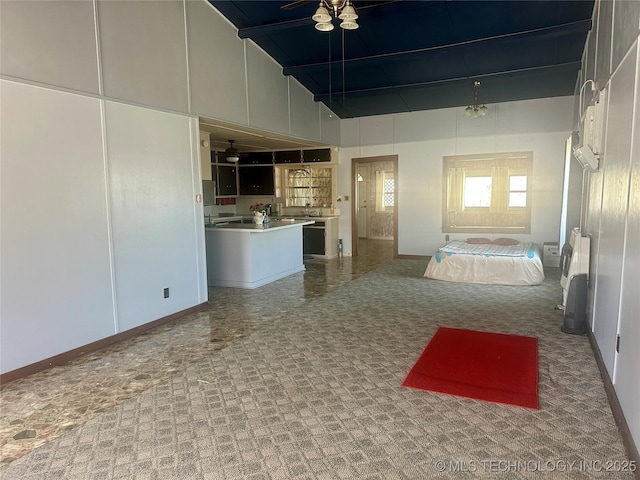unfurnished living room featuring high vaulted ceiling and baseboards