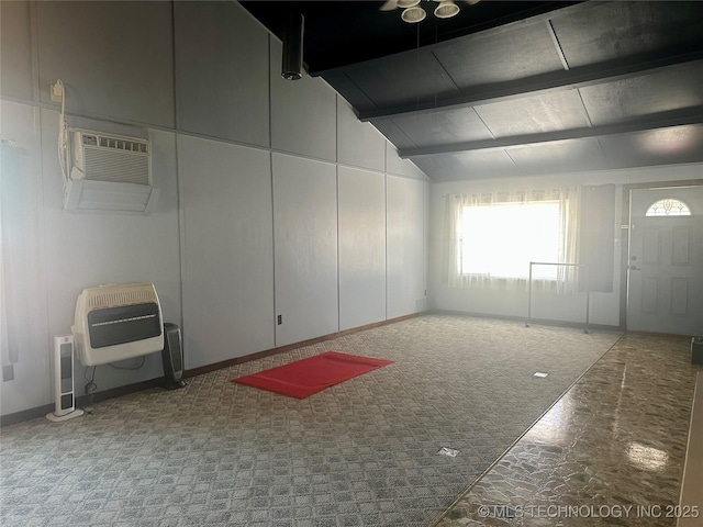 empty room with lofted ceiling with beams, heating unit, and carpet floors
