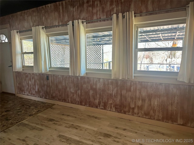 interior space with a healthy amount of sunlight and wood finished floors