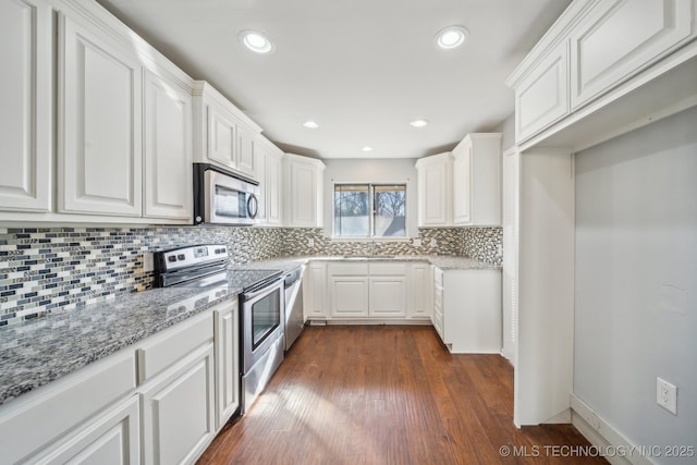 6924 S Knoxville Ave, Tulsa, OK 74136 - kitchen with stainless steel appliances, white cabinets, light stone countertops, decorative backsplash, and recessed lighting