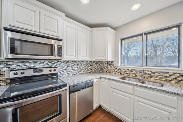 6924 S Knoxville Ave, Tulsa, OK 74136 - kitchen with appliances with stainless steel finishes, white cabinetry, backsplash, light stone countertops, and recessed lighting