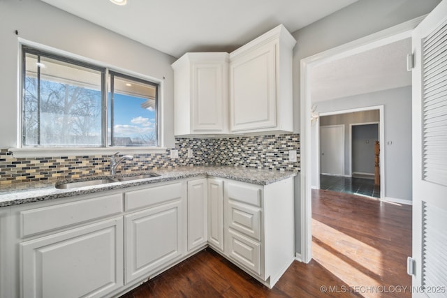 6924 S Knoxville Ave, Tulsa, OK 74136 - kitchen featuring backsplash, white cabinets, dark wood-style flooring, and light stone countertops