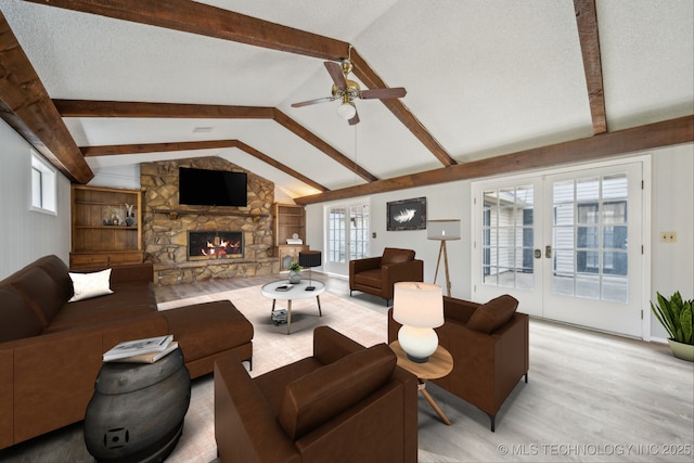 6924 S Knoxville Ave, Tulsa, OK 74136 - living area with ceiling fan, light wood-type flooring, a stone fireplace, and french doors