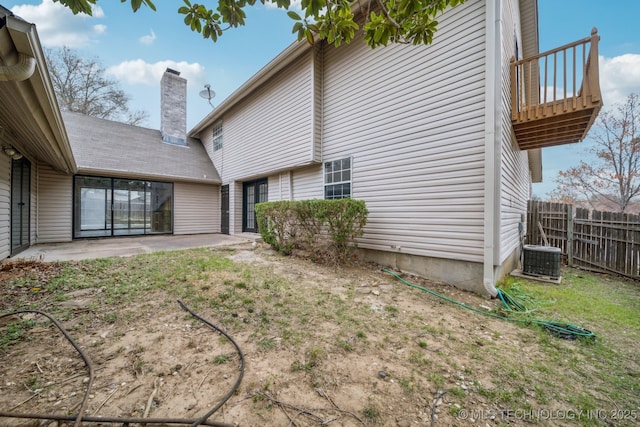 6924 S Knoxville Ave, Tulsa, OK 74136 - rear view of house featuring a chimney, a patio, and a balcony