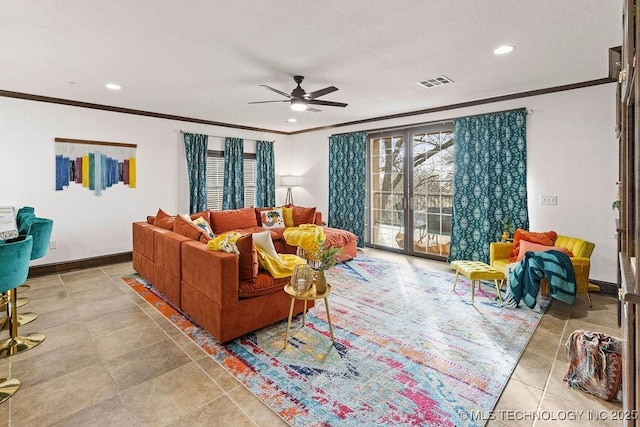 living room with a ceiling fan, crown molding, tile patterned floors, and visible vents