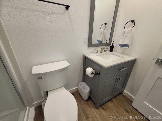 117700 S 4214th Rd, Eufaula, OK 74432 - bathroom featuring wood finished floors, vanity, toilet, and baseboards
