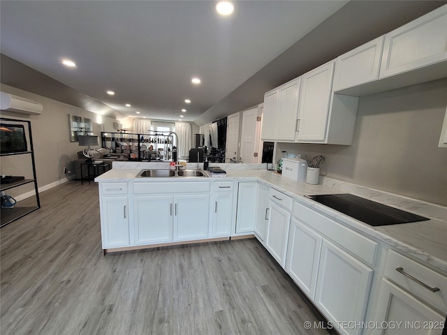 117700 S 4214th Rd, Eufaula, OK 74432 - kitchen with a peninsula, open floor plan, white cabinets, an AC wall unit, and light wood-style floors
