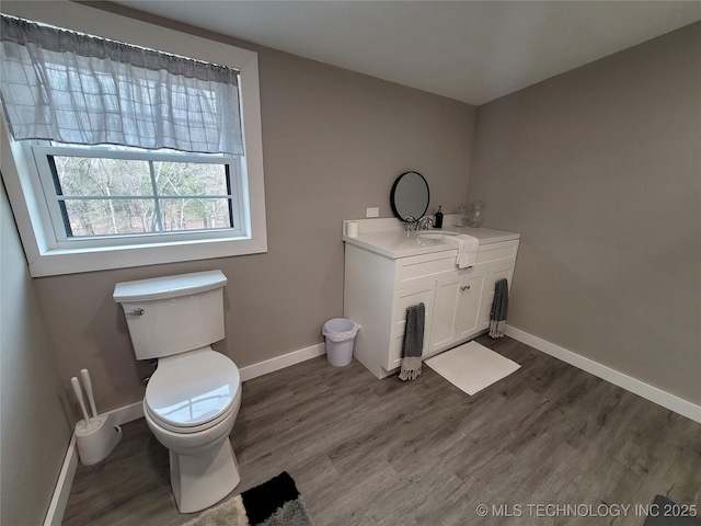 117700 S 4214th Rd, Eufaula, OK 74432 - bathroom with toilet, vanity, wood finished floors, and baseboards