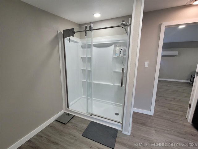 117700 S 4214th Rd, Eufaula, OK 74432 - full bathroom featuring a wall mounted AC, baseboards, a stall shower, and wood finished floors