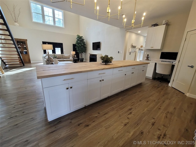 117700 S 4214th Rd, Eufaula, OK 74432 - kitchen featuring wooden counters, a chandelier, white cabinetry, dark wood-style floors, and a high ceiling