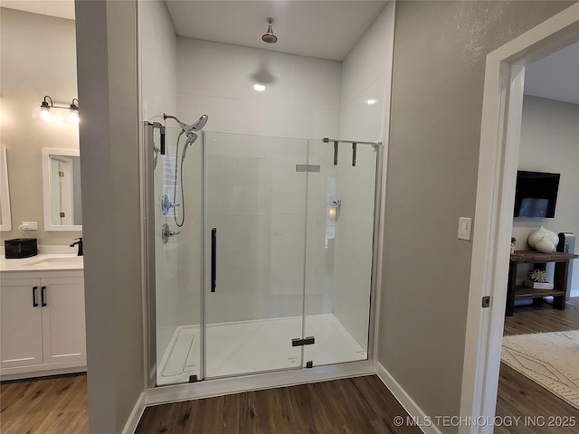 117700 S 4214th Rd, Eufaula, OK 74432 - bathroom featuring wood finished floors, a stall shower, vanity, and baseboards