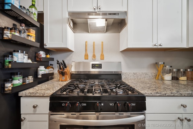 kitchen featuring under cabinet range hood, open shelves, white cabinets, gas range, and light stone countertops