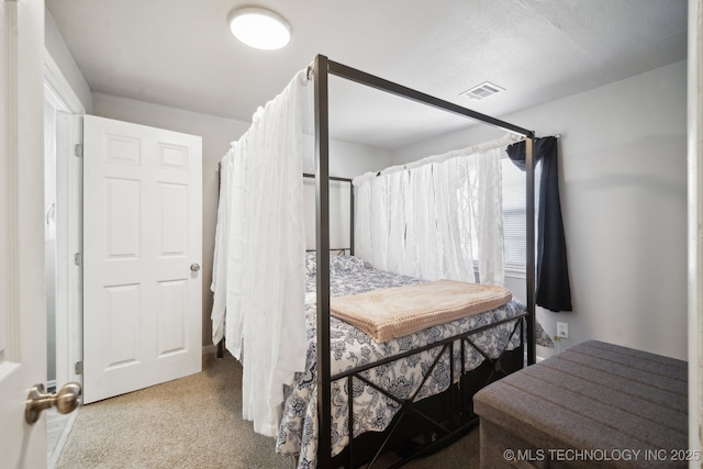 bedroom with visible vents and carpet floors