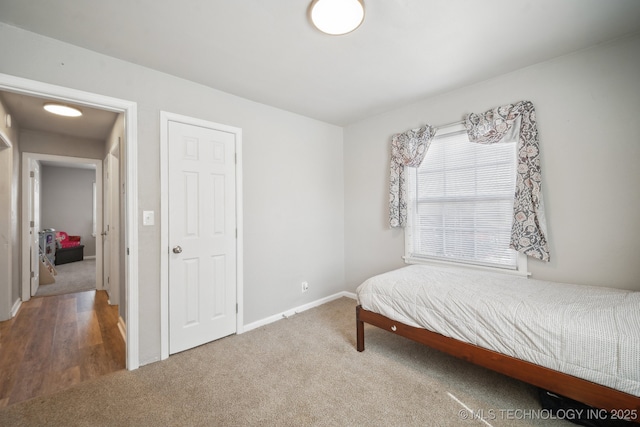 carpeted bedroom with baseboards