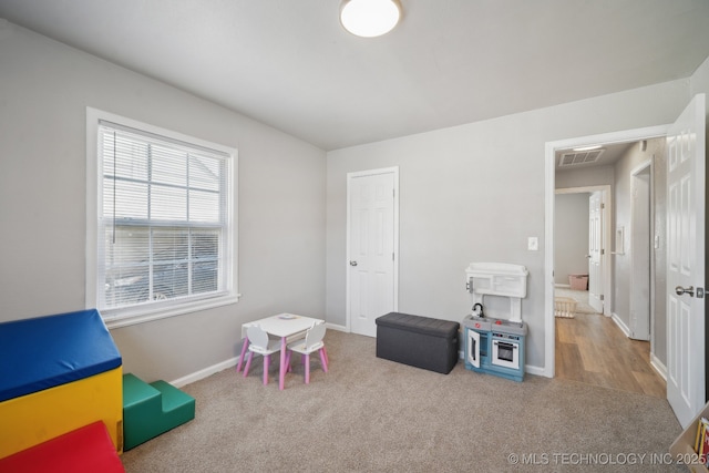rec room with carpet flooring, baseboards, and visible vents