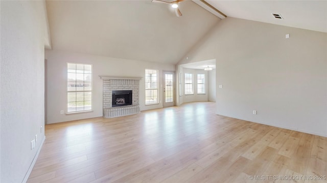 11762 N 156th E Ave, Collinsville, OK 74021 - unfurnished living room featuring ceiling fan, beamed ceiling, high vaulted ceiling, light wood finished floors, and a brick fireplace