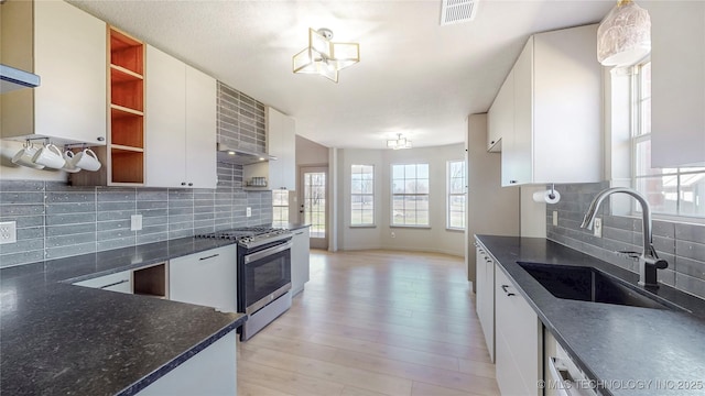 11762 N 156th E Ave, Collinsville, OK 74021 - kitchen with stainless steel gas stove, open shelves, a sink, tasteful backsplash, and white cabinets