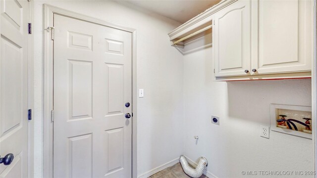 laundry area with baseboards, cabinet space, washer hookup, and hookup for an electric dryer