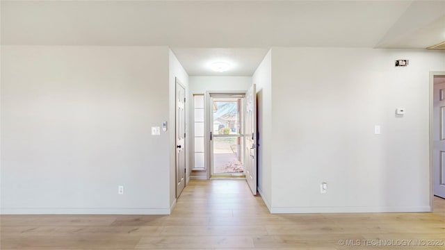 entrance foyer with baseboards and light wood-type flooring