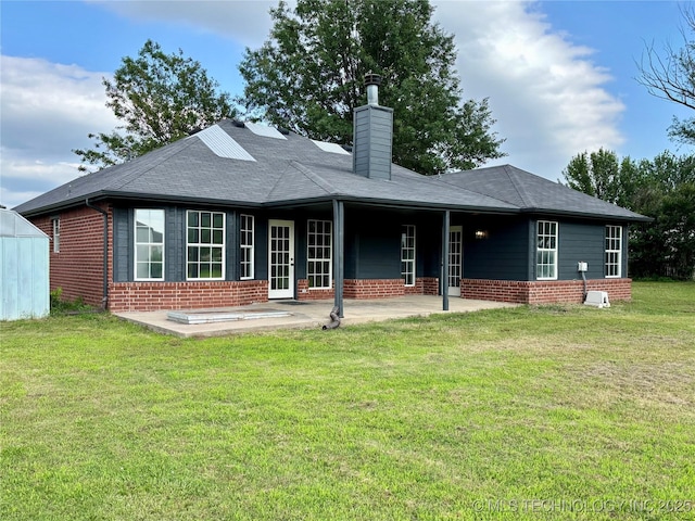 11762 N 156th E Ave, Collinsville, OK 74021 - rear view of house featuring brick siding, a patio area, a chimney, and a yard