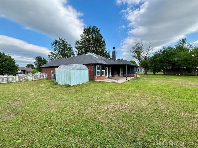 11762 N 156th E Ave, Collinsville, OK 74021 - back of property with a patio area, brick siding, and a chimney