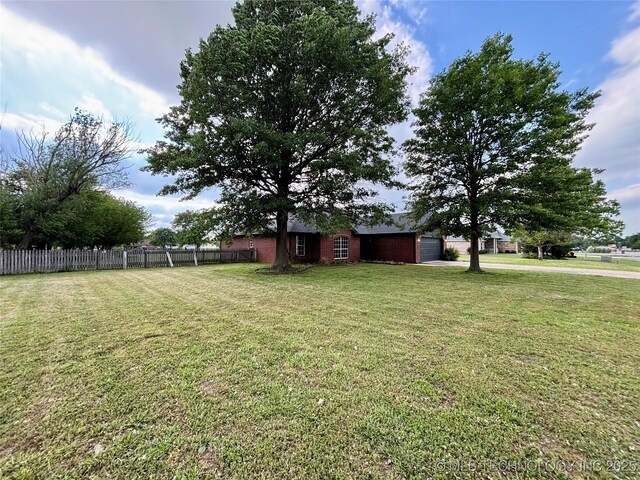 11762 N 156th E Ave, Collinsville, OK 74021 - view of yard featuring a garage and driveway