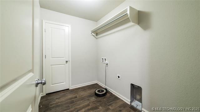 clothes washing area with dark wood-type flooring, hookup for an electric dryer, baseboards, and laundry area