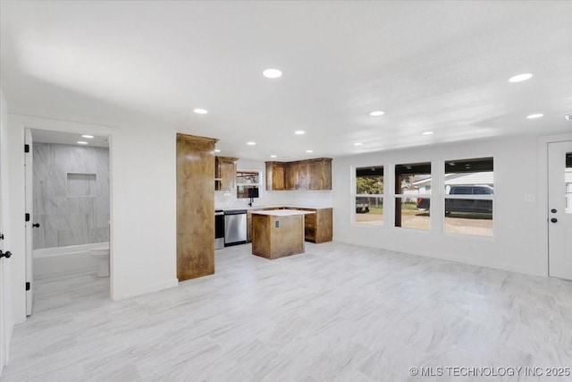 62 Jolene Reid Rd, Mead, OK 73449 - kitchen with stainless steel dishwasher, open floor plan, a center island, brown cabinetry, and light countertops