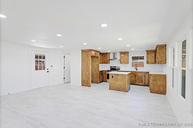 62 Jolene Reid Rd, Mead, OK 73449 - kitchen featuring a center island, wall chimney range hood, recessed lighting, brown cabinets, and electric range