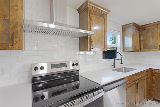 62 Jolene Reid Rd, Mead, OK 73449 - kitchen featuring backsplash, brown cabinets, appliances with stainless steel finishes, wall chimney exhaust hood, and a sink