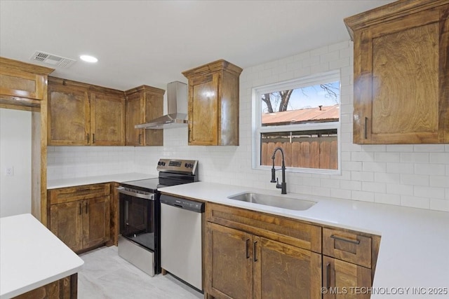 62 Jolene Reid Rd, Mead, OK 73449 - kitchen featuring visible vents, a sink, decorative backsplash, appliances with stainless steel finishes, and wall chimney exhaust hood