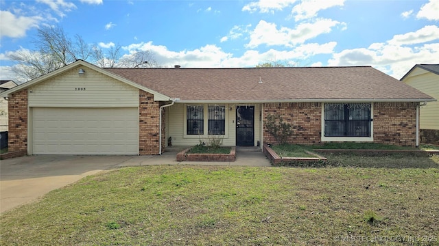 ranch-style house with driveway, a shingled roof, a front yard, an attached garage, and brick siding