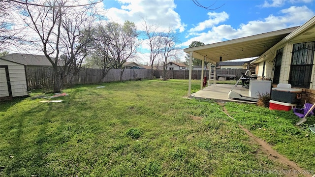 view of yard featuring a storage shed, an outbuilding, and a fenced backyard