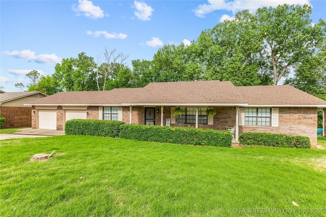 401 S 14th, Ada, OK 74820 - ranch-style house featuring brick siding, an attached garage, a front yard, and driveway