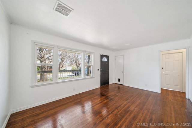 unfurnished living room with ornamental molding, wood finished floors, visible vents, and baseboards